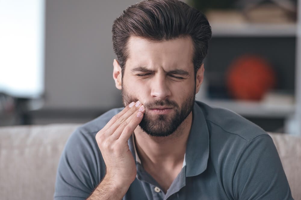 Picture of a man experiencing from toothache