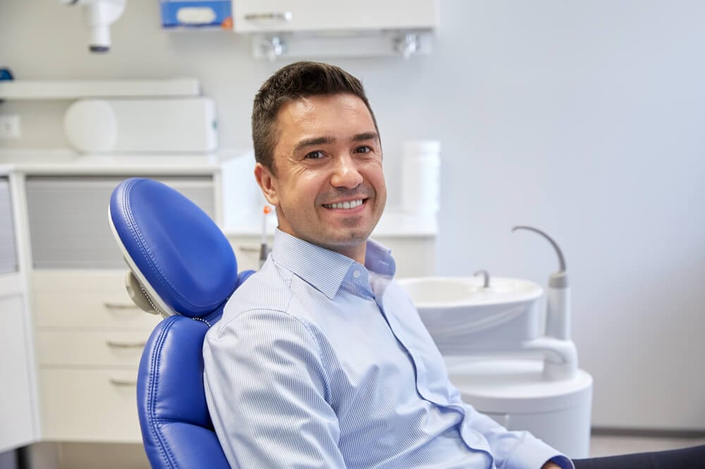 A man on a dental chair ready for cleanings procedure.
