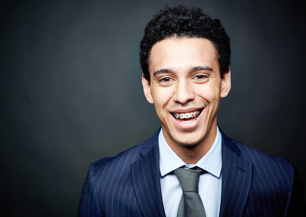teenager with braces smiling, suit