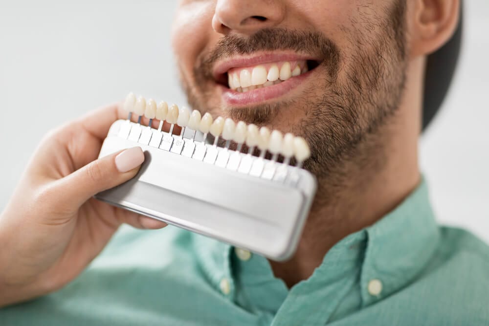 featured imaged for services post, smiling dental patient choosing whitening product