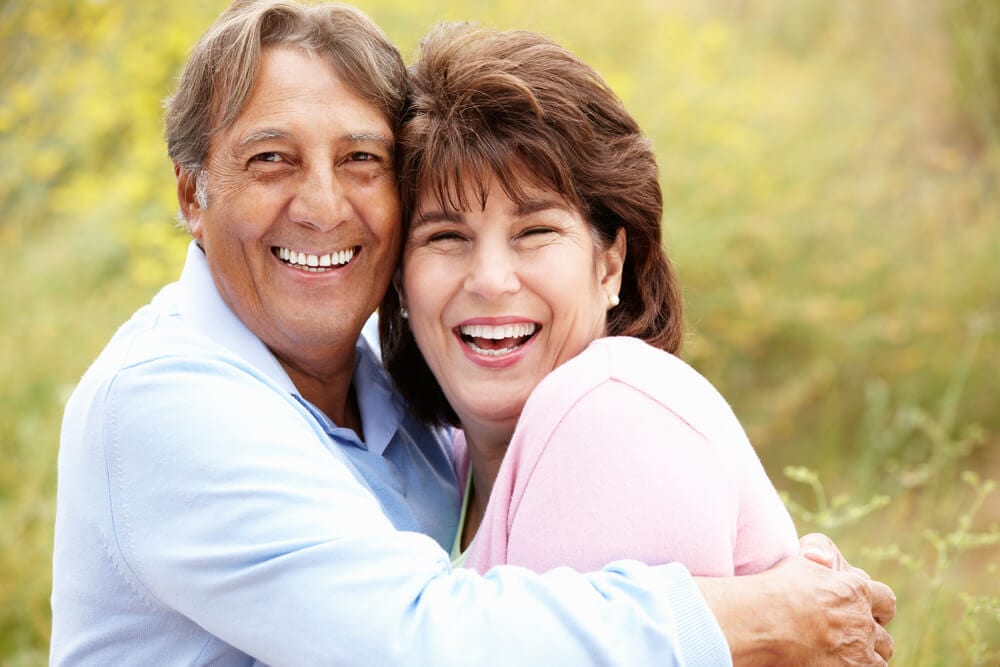 Picture of a couple who are so happy with their restored teeth.